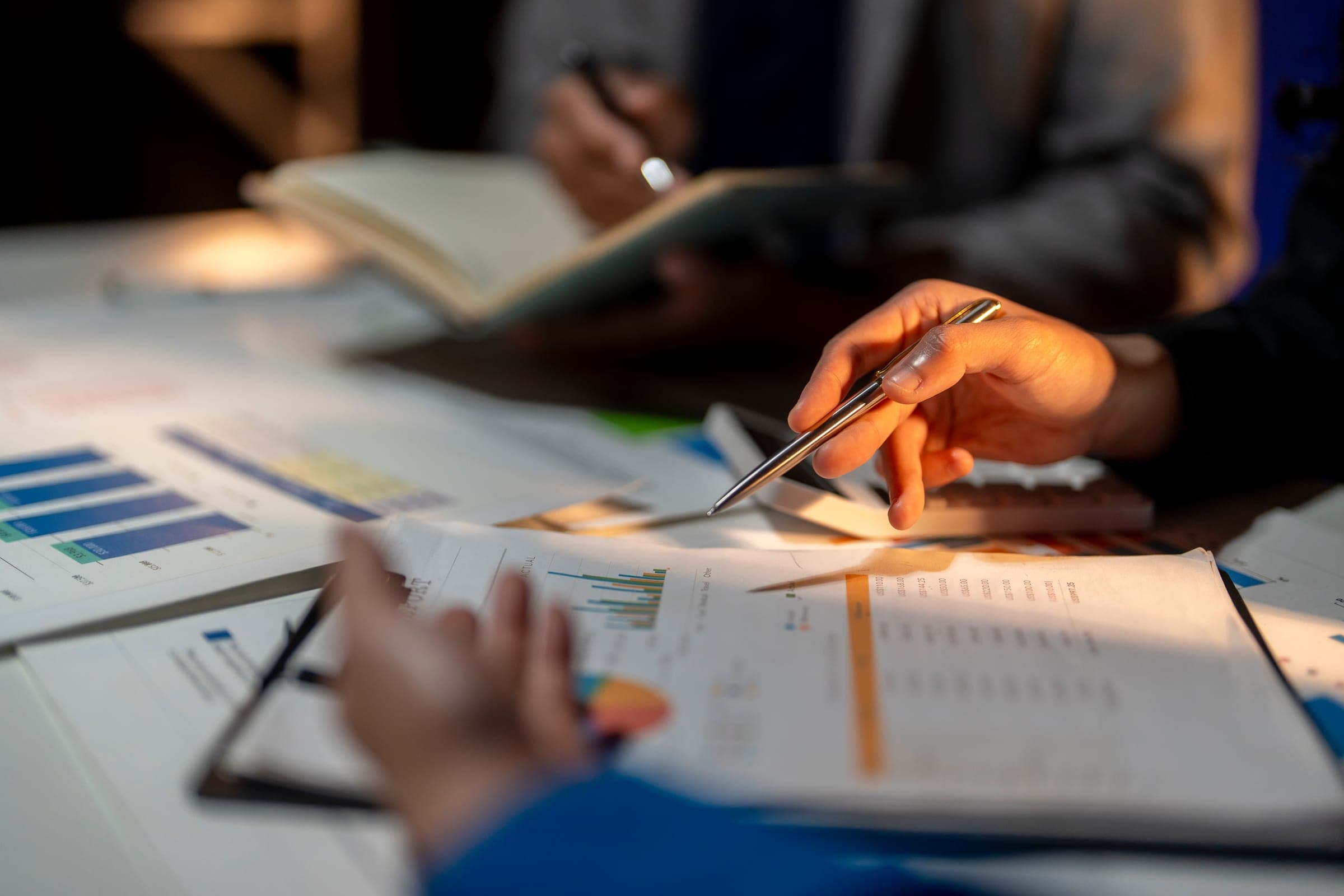 Advisors reviewing project financial data and charts during a working session